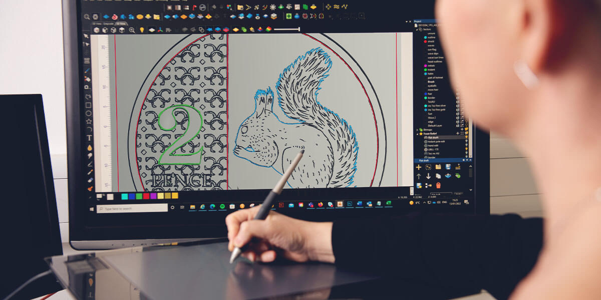 A woman working at a computer designing the 2023 Definitive two pence coin on screen.